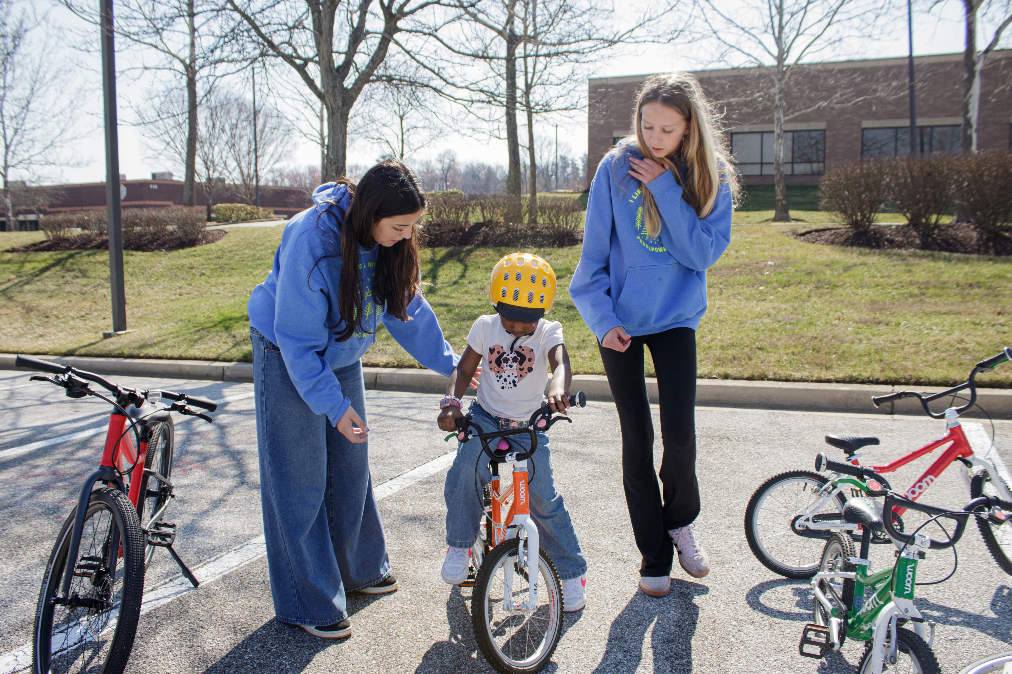 TCP Mentors in Training participant teaching a young child to ride a bike