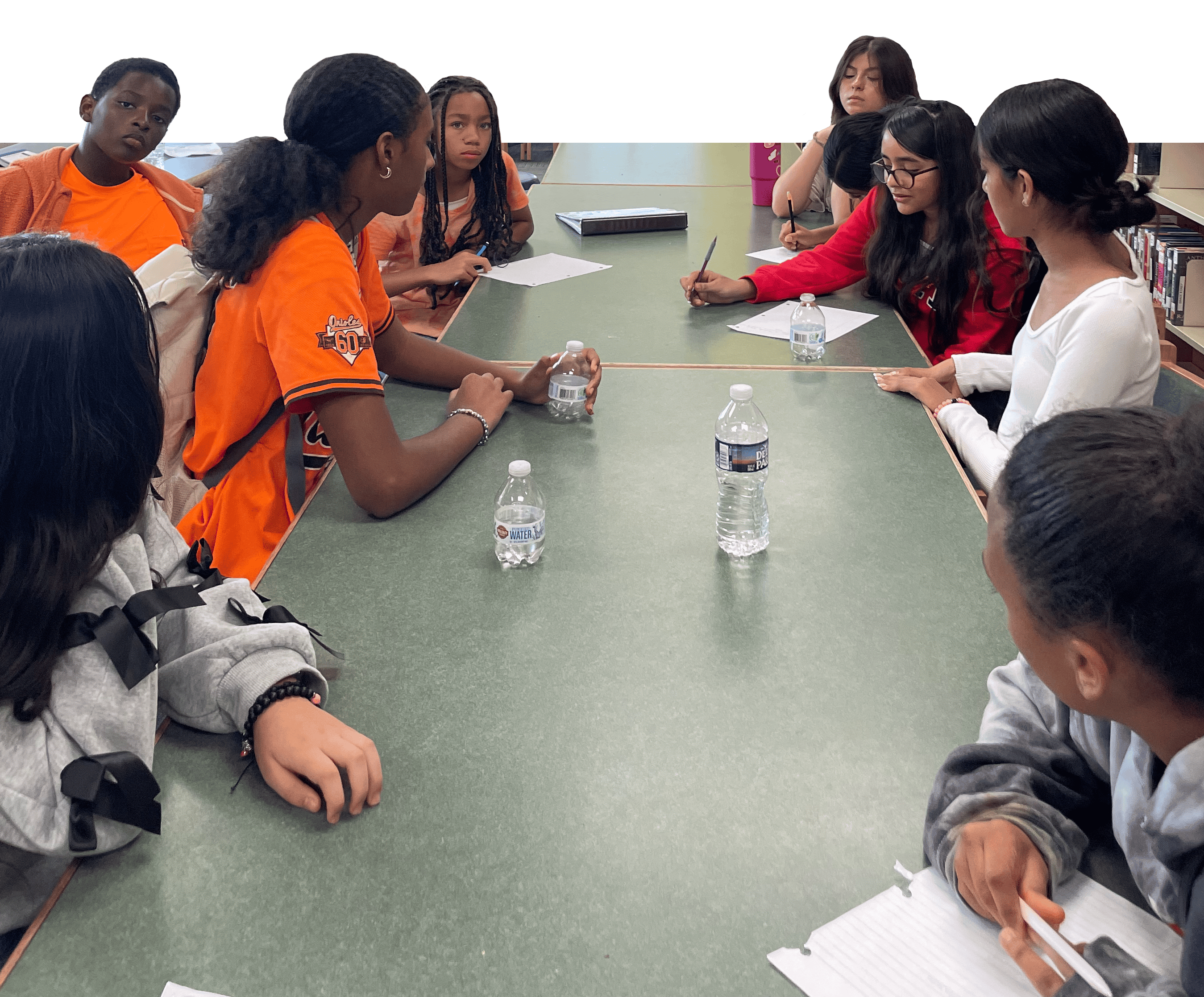 A group of young mentors at a long table.